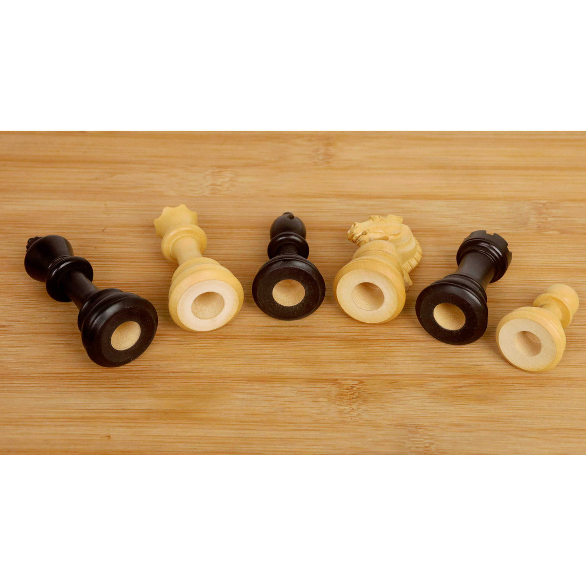 Hollow bases of ebonised and boxwood chess pieces compatible with Chessnut Air electronic boards.