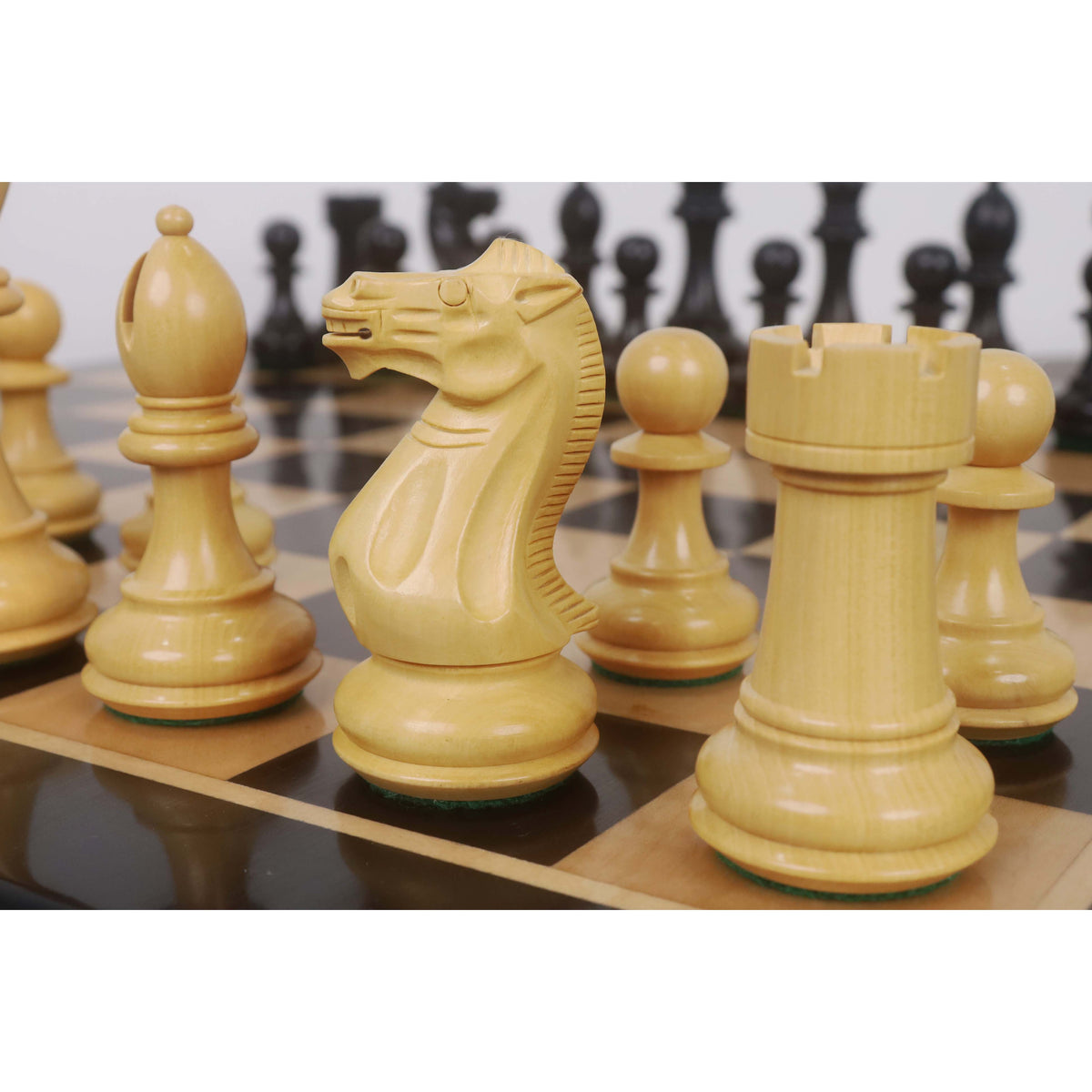 Detailed view of Boxwood Pro Staunton Knight and Rook on a wooden chessboard.