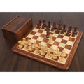 Taj Mahal Staunton chess pieces set up on a wooden board next to a matching storage box.
