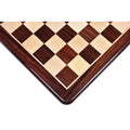 Corner view of a 21-inch rosewood and maple wood chess board with 55 mm squares and rounded edges.