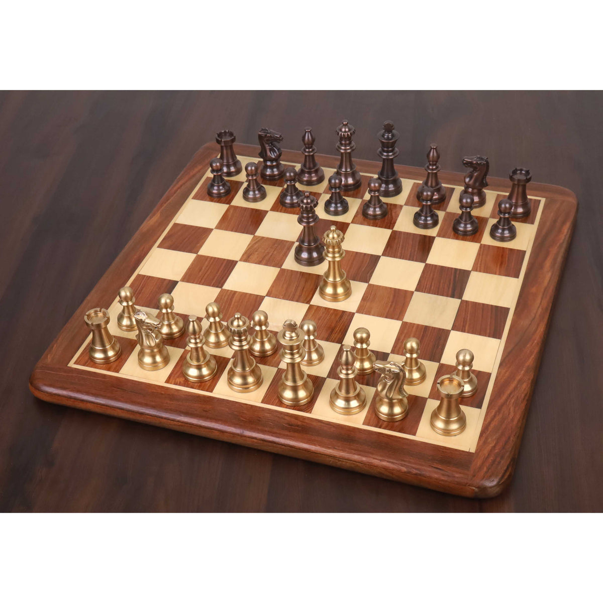Complete Pro Staunton brass metal luxury chess set in copper and antique finishes arranged on a board.
