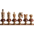 Profile lineup of metallic gold Victorian Fusion brass luxury chess pieces from King to Pawn with wooden bases.