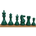 Complete set of weighted green Staunton chess pieces arranged on a wooden board.