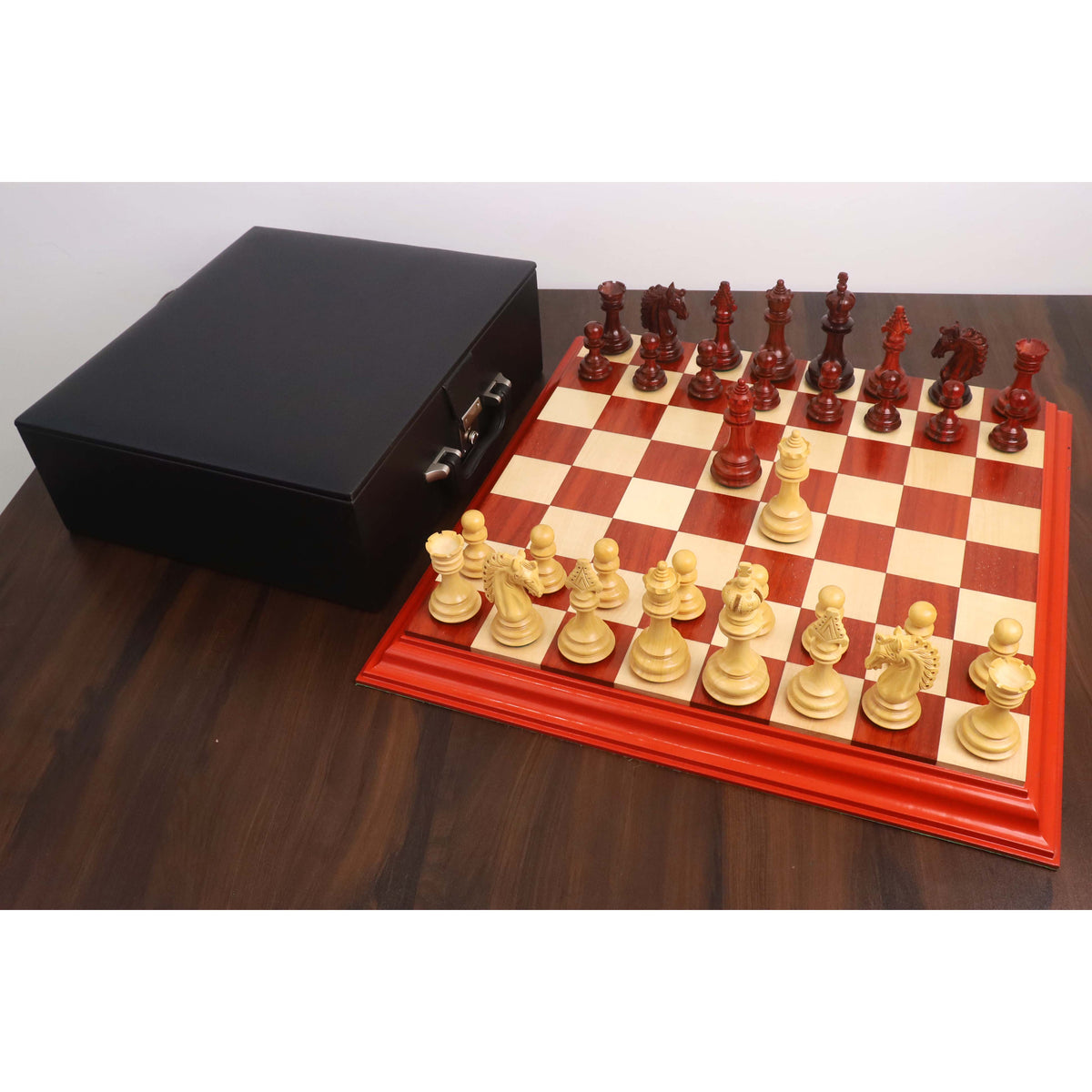 Full 4.5-inch Carvers' Art luxury chess set arranged on a budrose and maple wood board.