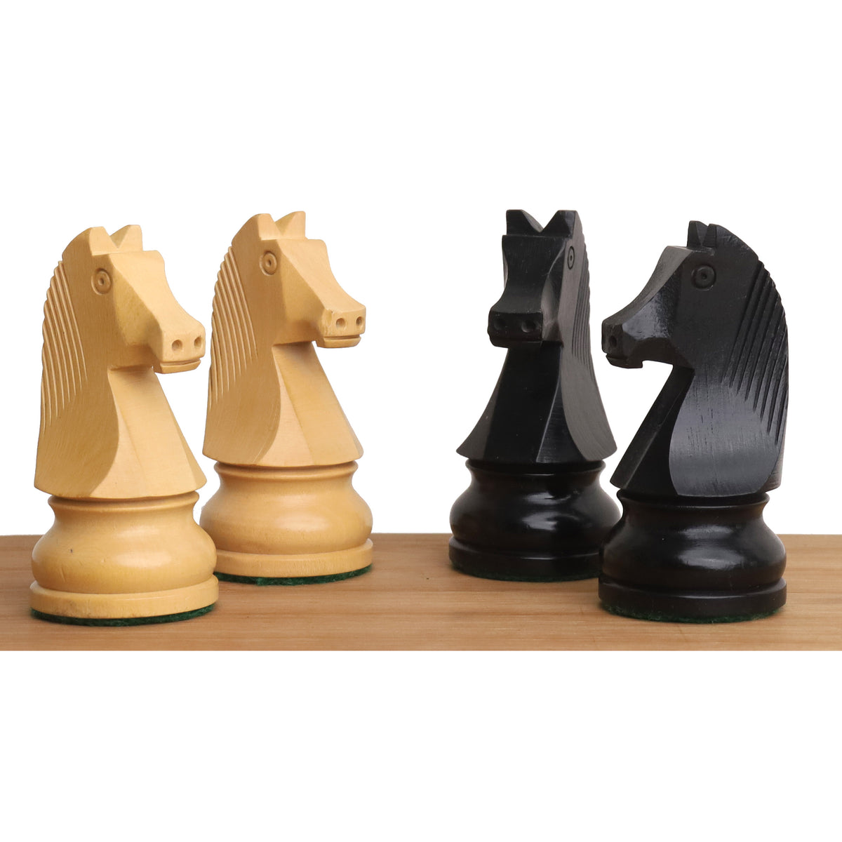 Close-up of tournament chess knights crafted in natural boxwood and ebonized wood finishes.