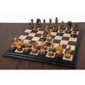 Full Alexandria Staunton burnt carving chess set arrayed on a luxury wooden chessboard.