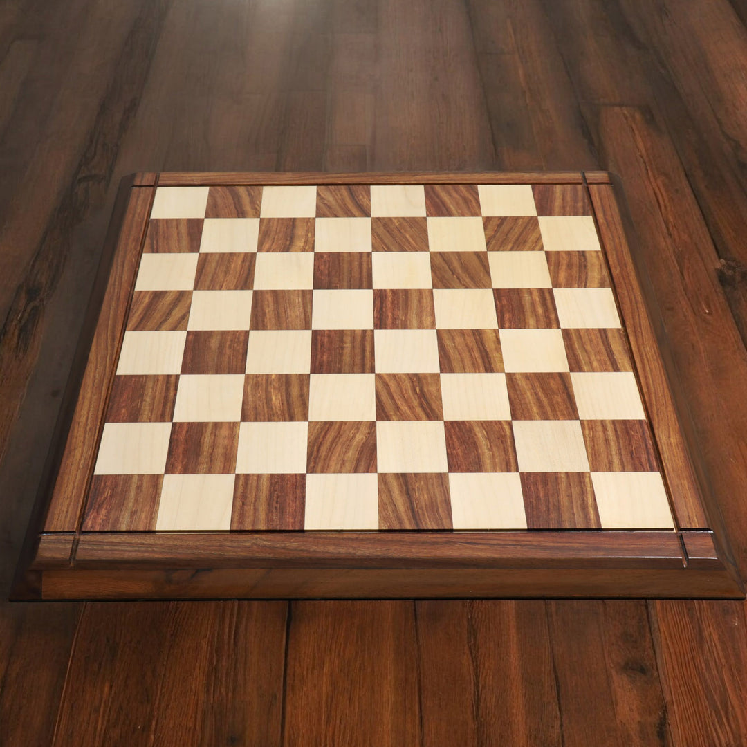 Top-down lifestyle view of a 21 inch solid golden rosewood and maple wood chess board on a wooden floor.