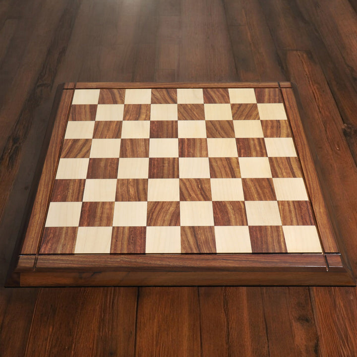 Top-down lifestyle view of a 21 inch solid golden rosewood and maple wood chess board on a wooden floor.