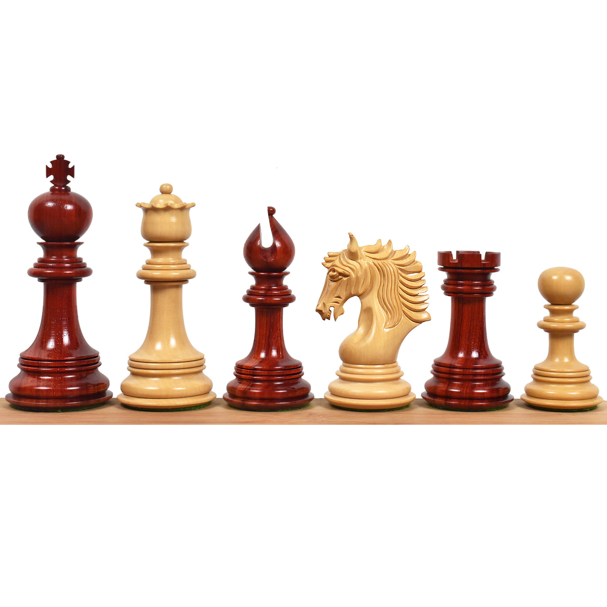Six Arthur Luxury Staunton chess pieces lined up on a wooden base showcasing detailed artisan carvings.