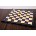 Large 26 inch ebony and maple wood printed chess board with 70mm squares on a wooden table.
