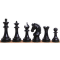 Lineup of black texture painted Staunton chess pieces from King to Pawn on a wooden surface.