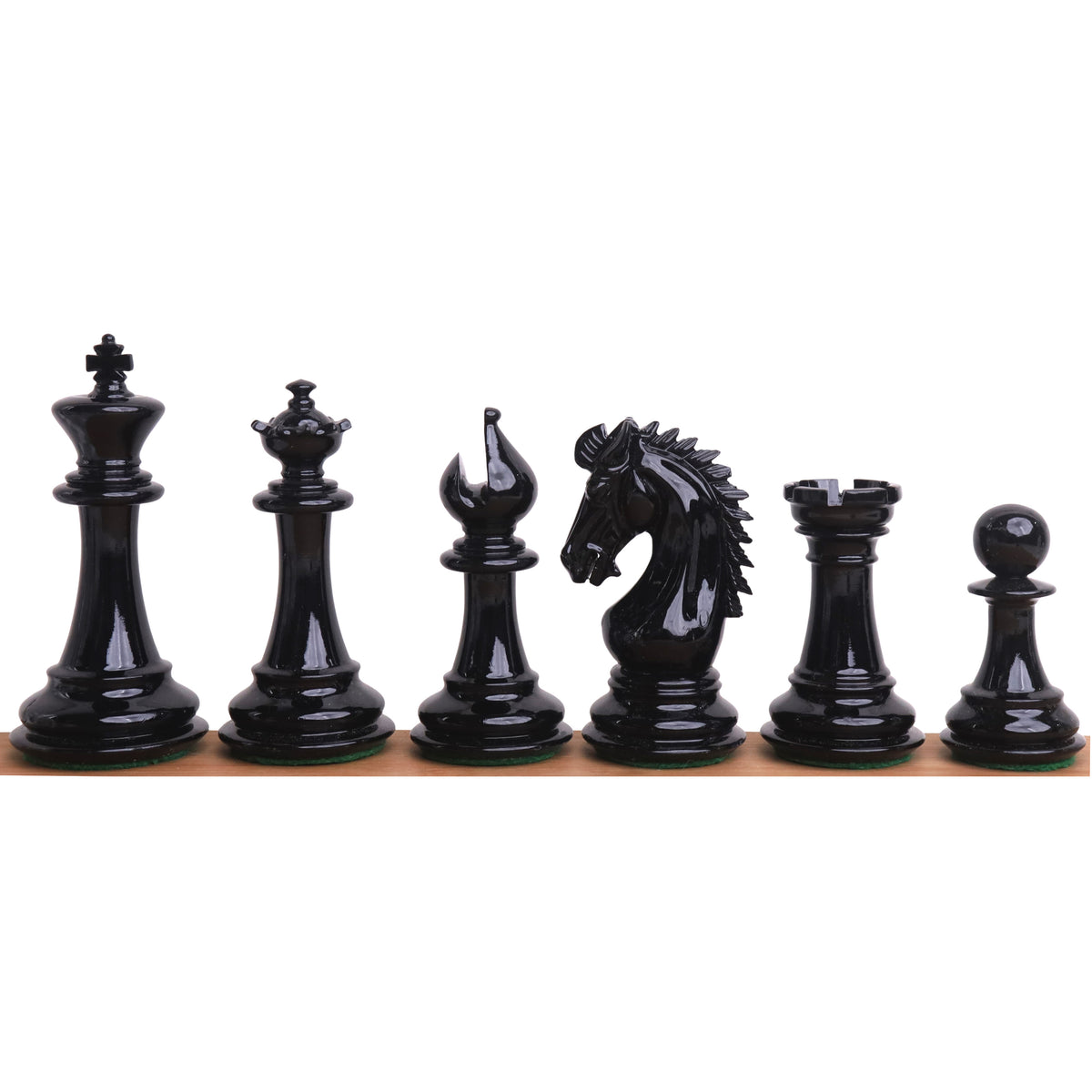 Lineup of black texture painted Staunton chess pieces from King to Pawn on a wooden surface.