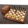 Full championship ebonised boxwood chess set arranged on a wooden board next to a wooden storage box.
