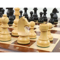 Close-up of a natural boxwood knight and rook on a wooden board, with black ebonised pieces blurred behind.