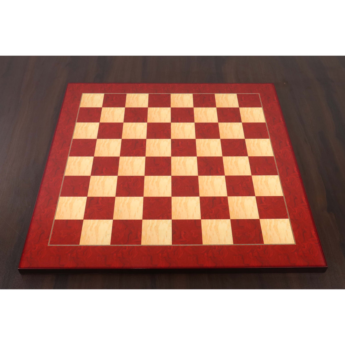 Full top-down perspective of a 21-inch Red Ash Burl & Burl Boxwood printed chess board on a dark wood table.