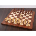 Modern minimalist chess pieces arranged on a premium wooden chess board.