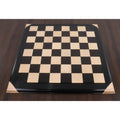 Full top-down view of a professional 21 inch luxury wooden chessboard with 55mm squares on a dark wood table.