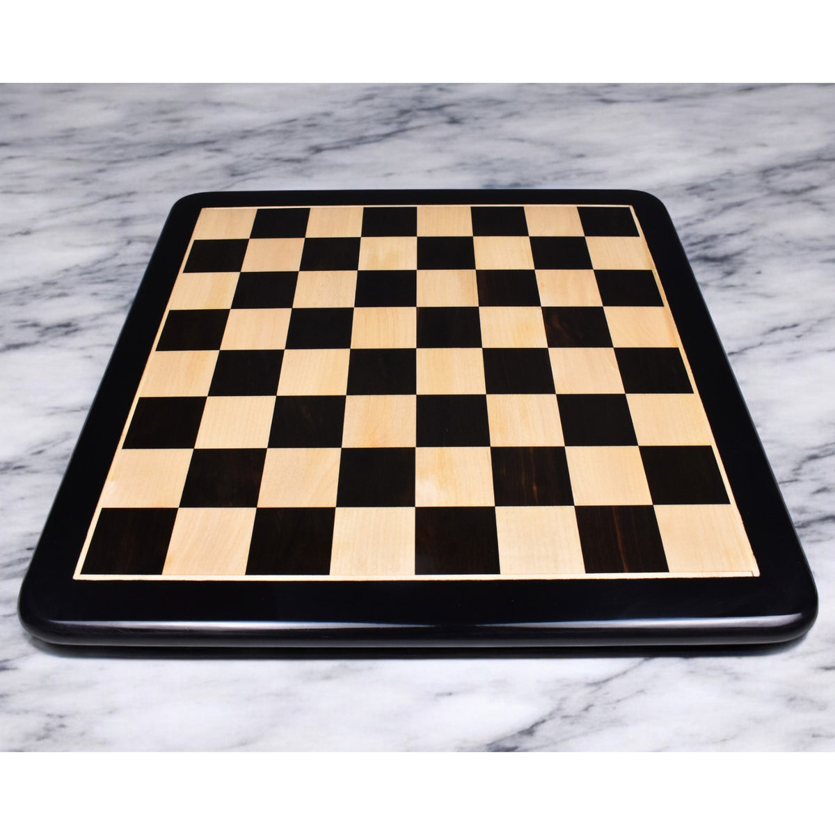Full view of a 19-inch solid inlaid ebony and maple wood chess board with 50 mm squares.