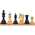 Napoleon luxury Staunton chess pieces in dark ebony and natural boxwood lined up on a wooden base.