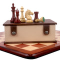 Alban Staunton bud rosewood chess pieces resting on a storage box over a wooden board.