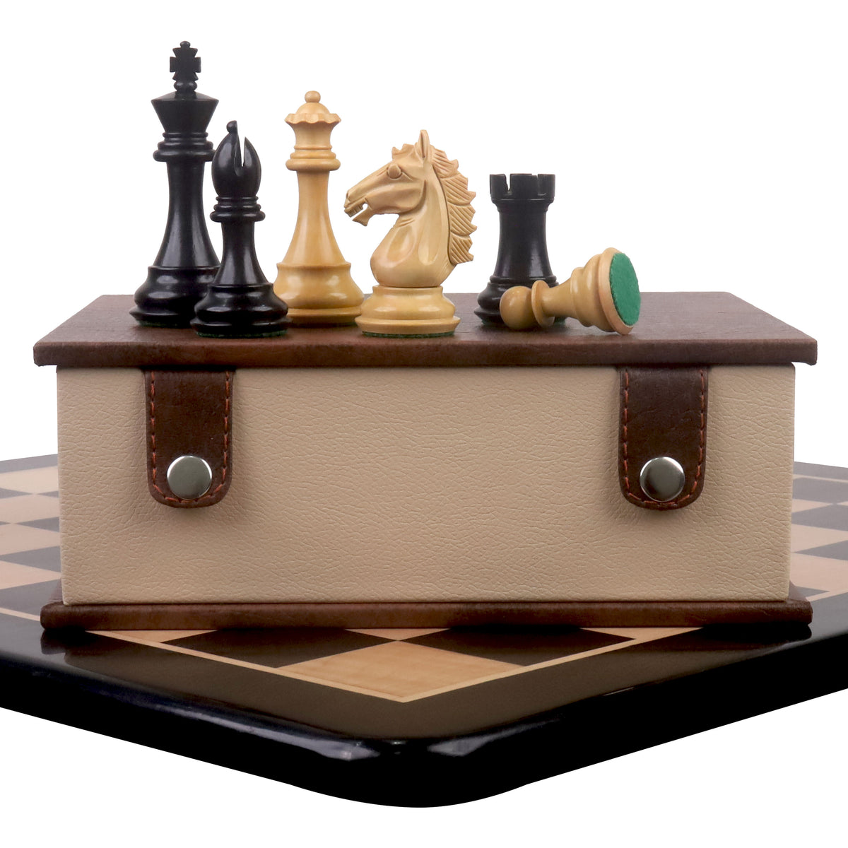 Alban Staunton chess set combo showing pieces on a leatherette storage box resting on a wooden chessboard.
