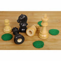Ebonised and boxwood chess pieces with unattached green felt pads, showing the sensor-ready hollow base.