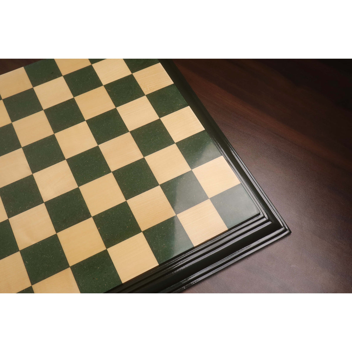 Glossy green and maple wood chess board squares with polished decorative frame.
