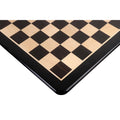 Crisp alternating dark ebony and light maple wooden squares of a luxury chess board.