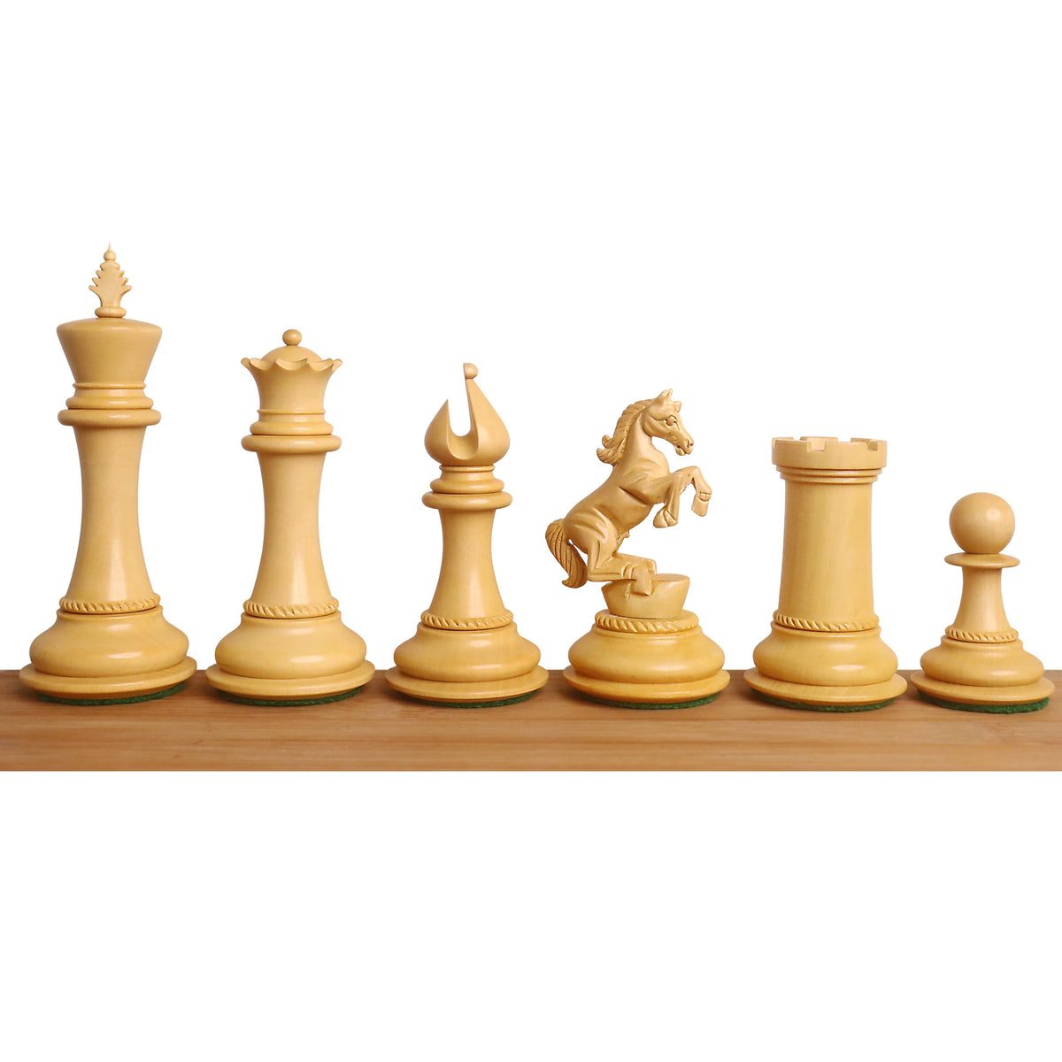Lineup of boxwood Incitatus luxury Staunton chess pieces from King to Pawn on a light wood surface.