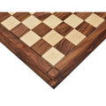 Detailed corner view of a handcrafted wooden chess board with precise square inlays.