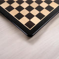 Macro view of the polished wooden chess board corner and custom framing.