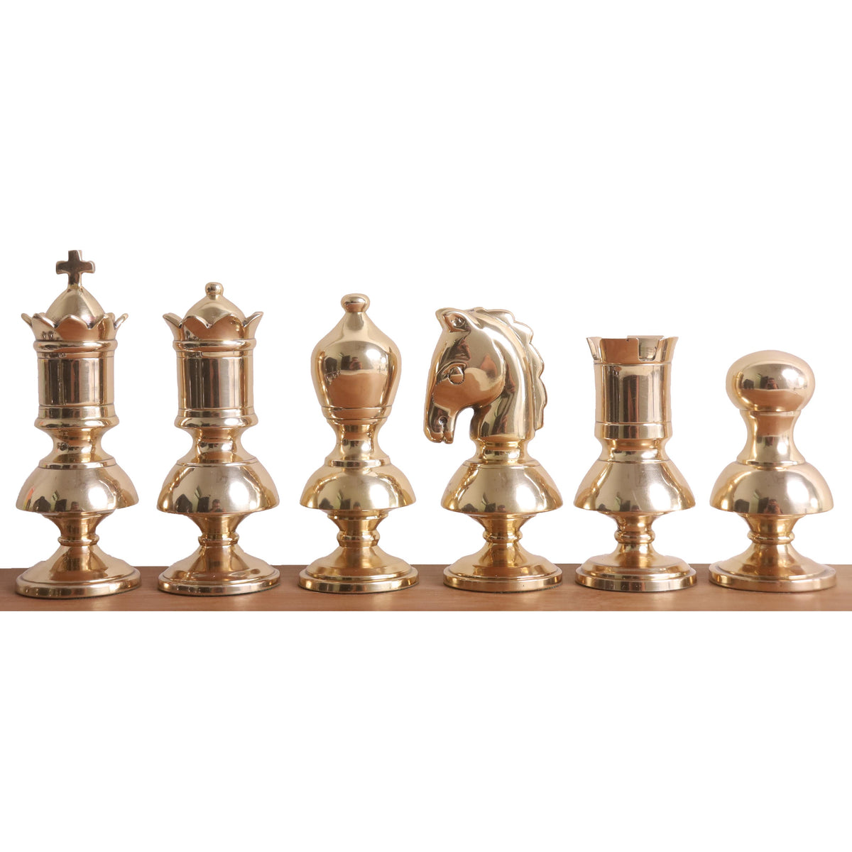 Metallic gold Victorian brass chess pieces arranged in a row from King to Pawn.