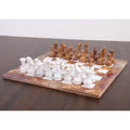 Full view of the 15-inch brown onyx marble and stone chess pieces and board set on a dark surface.