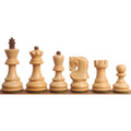 Hand-carved boxwood Zagreb style chess pieces from King to Pawn displayed on a wooden surface.