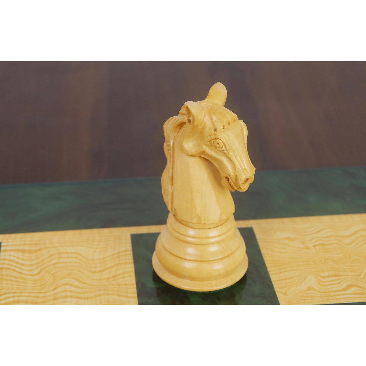Single handcrafted Columbian knight chess piece in boxwood on the chessboard.