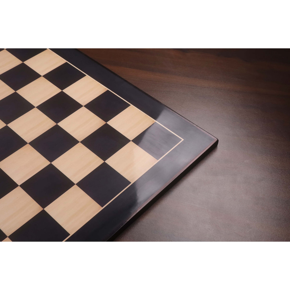 High-gloss 26 inch ebony and maple chess board showing reflective 70mm square playing surface.