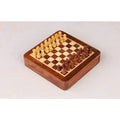 Full setup of the golden rosewood magnetic travel chess set on the board.