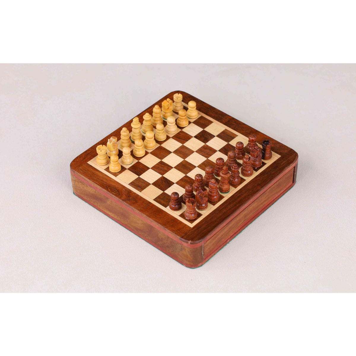 Full setup of the golden rosewood magnetic travel chess set on the board.
