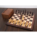 Tournament rosewood and boxwood chess set fully set up on a wooden chessboard next to its storage box.