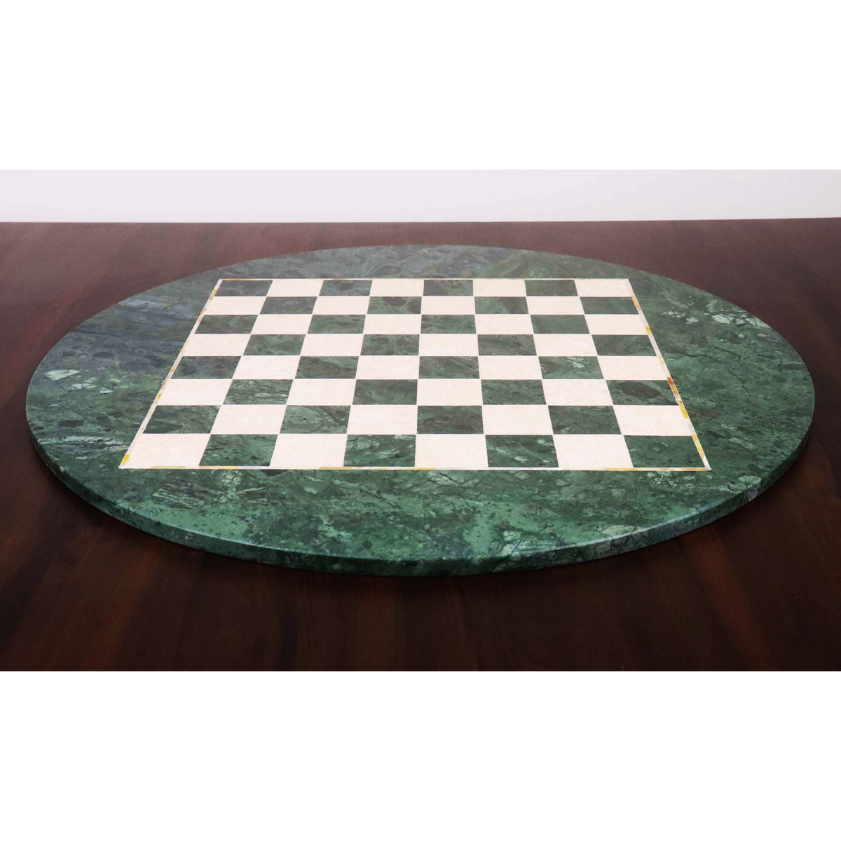 Side profile of a 24-inch circular luxury chess board made of green marble and semi-precious stones, highlighting its sleek, polished edge.