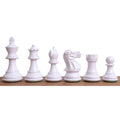 A complete row of white Pro Staunton painted wooden chess pieces from King to Pawn on a wooden surface.