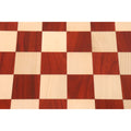Detailed texture of bud rosewood and maple wood playing squares on a luxury chessboard.