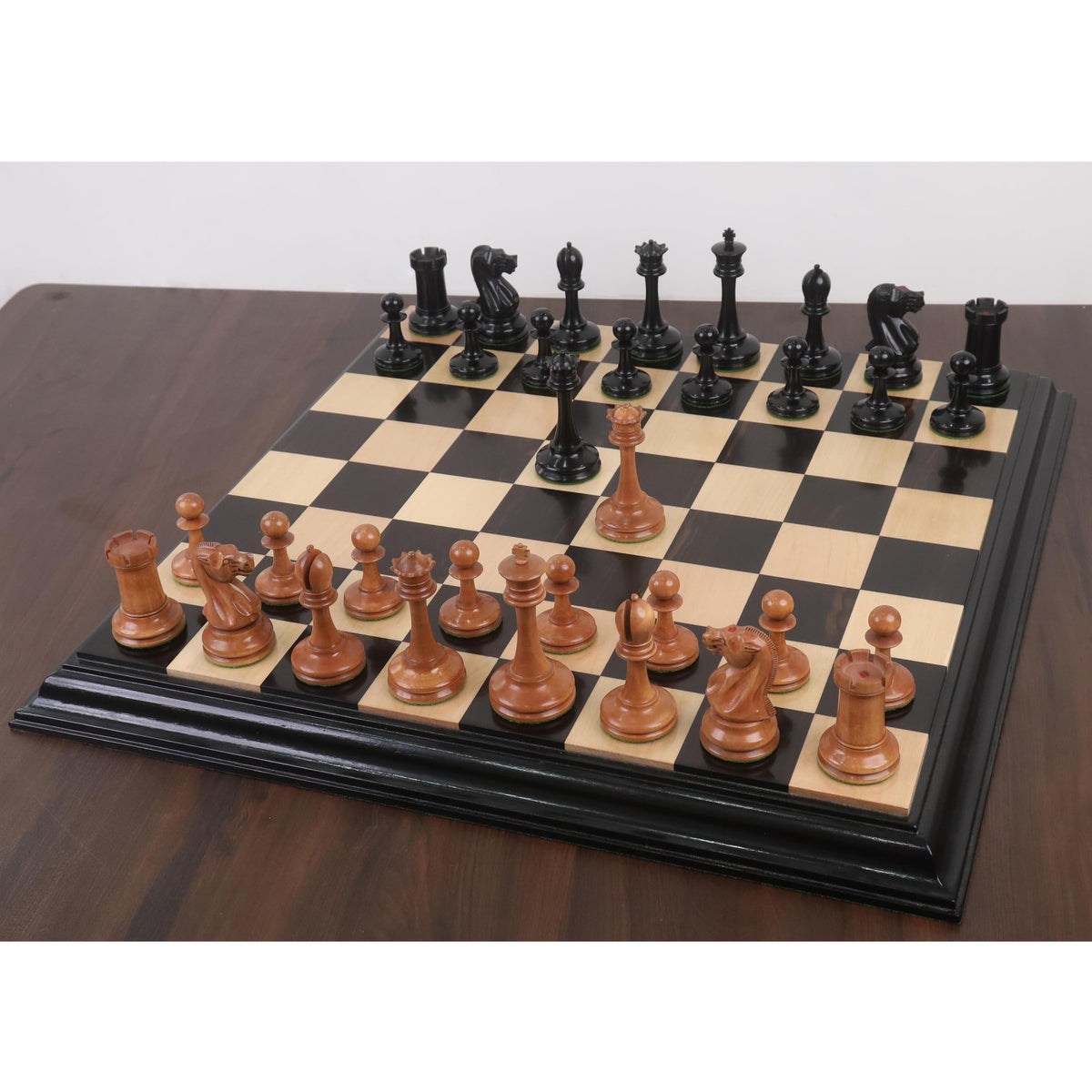 Luxury 19th Century B & Co reproduction chess pieces displayed on a premium wooden chess board.
