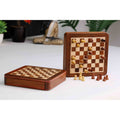 Premium golden rosewood magnetic travel chess set displayed in a home setting.
