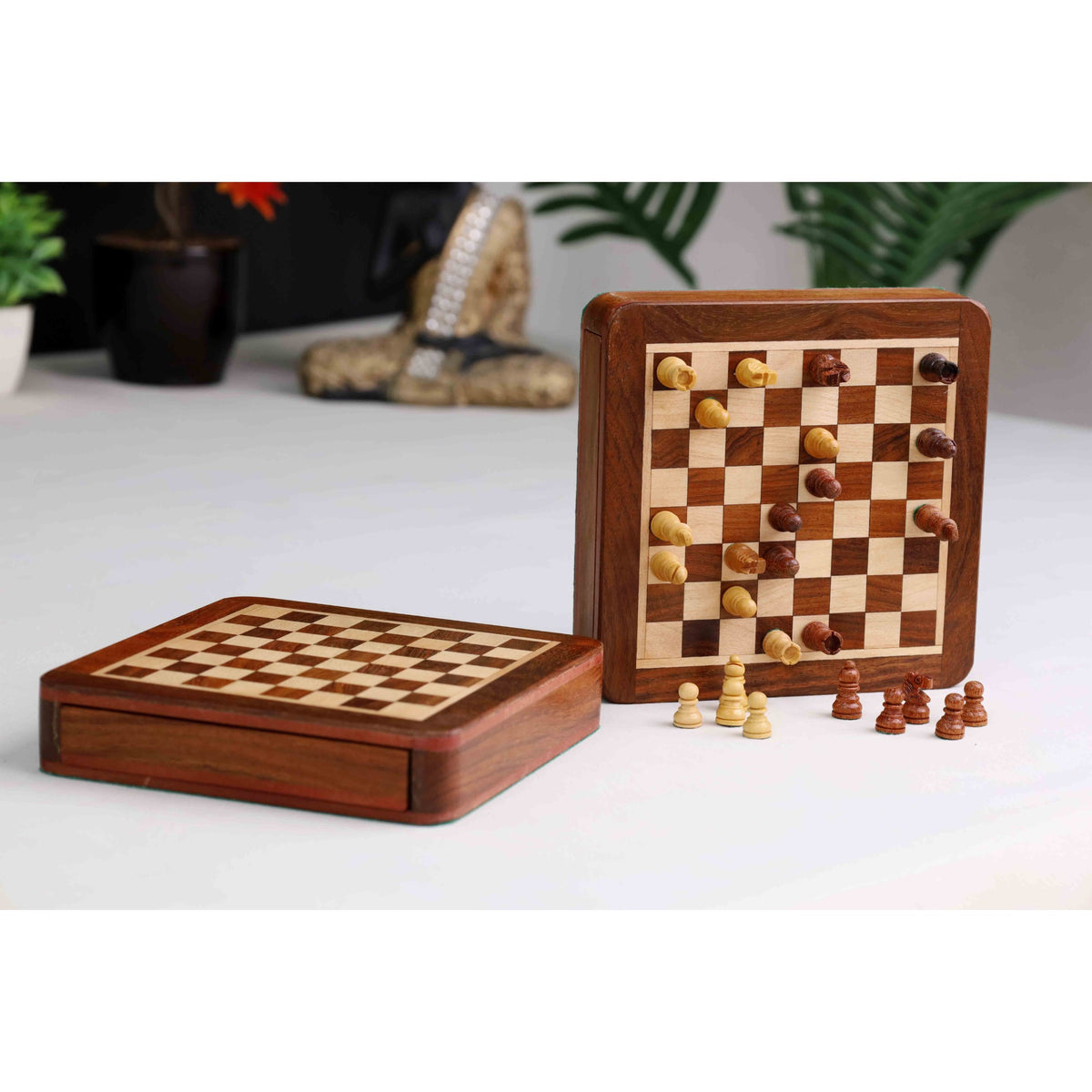 Premium golden rosewood magnetic travel chess set displayed in a home setting.