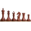 Complete lineup of minimalist golden rosewood chess pieces from king to pawn.
