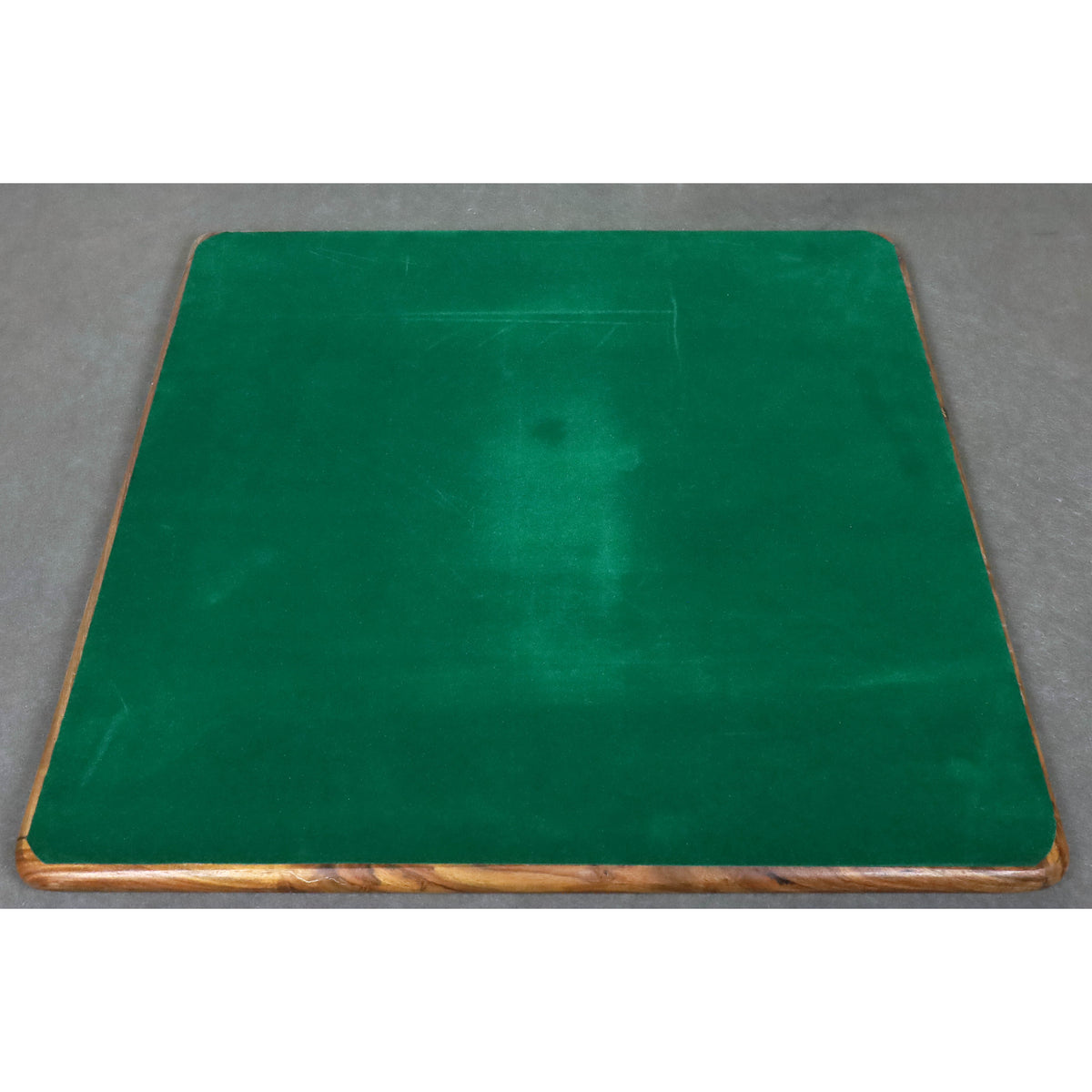 Underside of a large wooden chess board covered in premium green felt for surface protection.