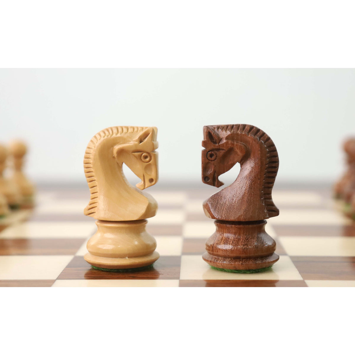 Close-up of opposing Russian Zagreb knights in golden rosewood and boxwood.