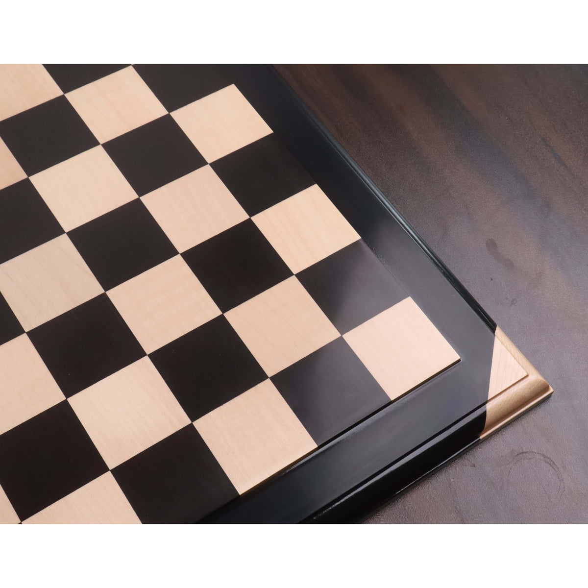 High-angle perspective of the premium Ebony and Maple wood chessboard highlighting the smooth finish and 55mm square size.