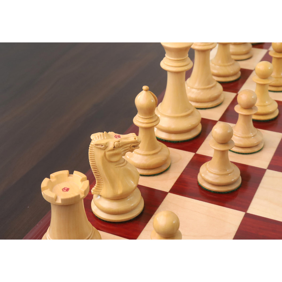 Angled view of boxwood chess pieces on a wooden board